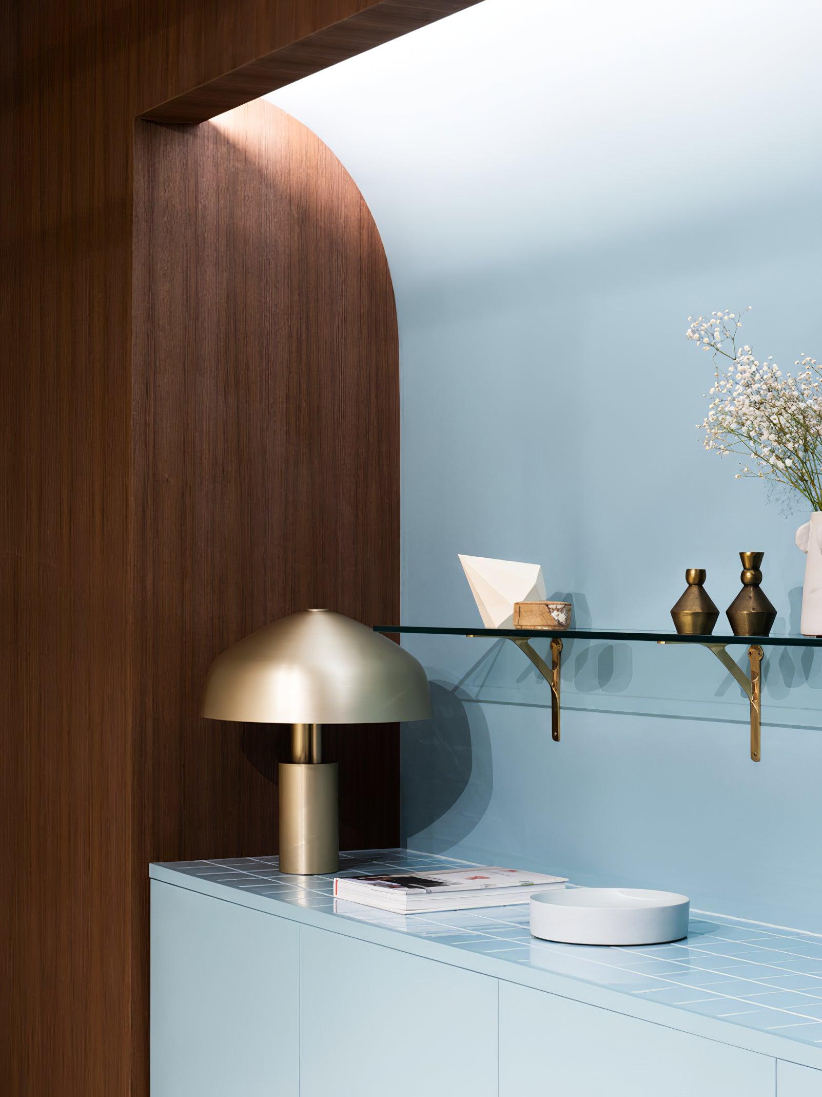 Gold dome table lamp on pale sideboard