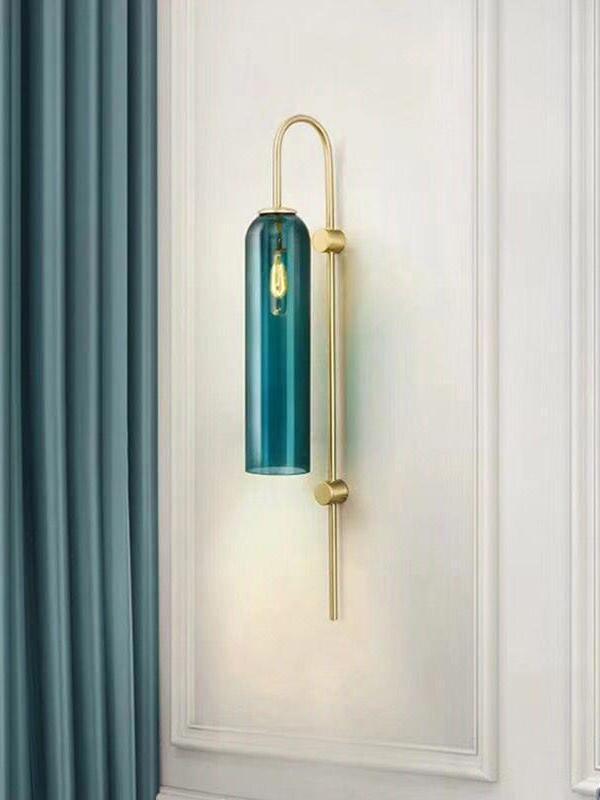 Blue glass cylinder against a pale paneled wall