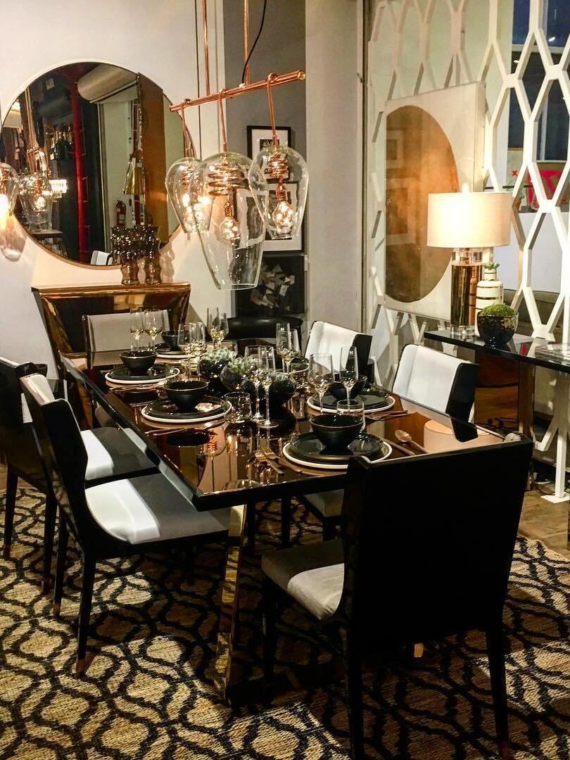 White-shade gold-tone lamp among chandeliers and mirrors in dining-room display