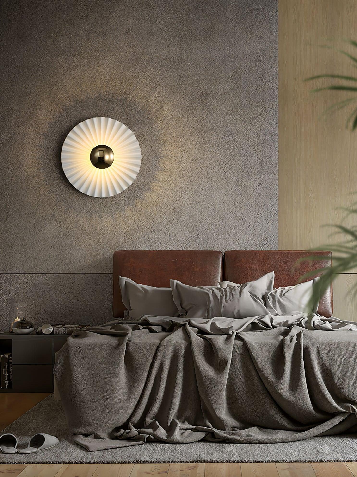 White pleated wall disc over dark bedhead