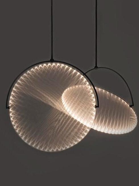 Two glowing disc pendants against a dark background