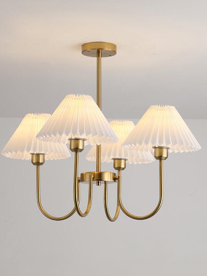 Closer view of glowing pleated chandelier shades against a pale background