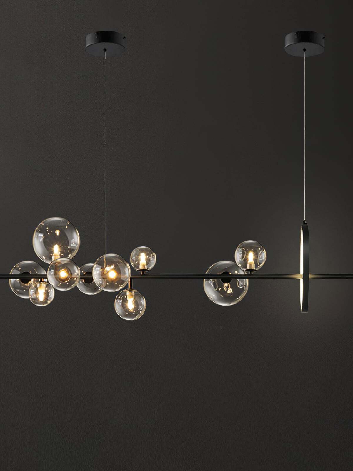 Long black chandelier with clear glass globes, an upright LED ring and two round canopies