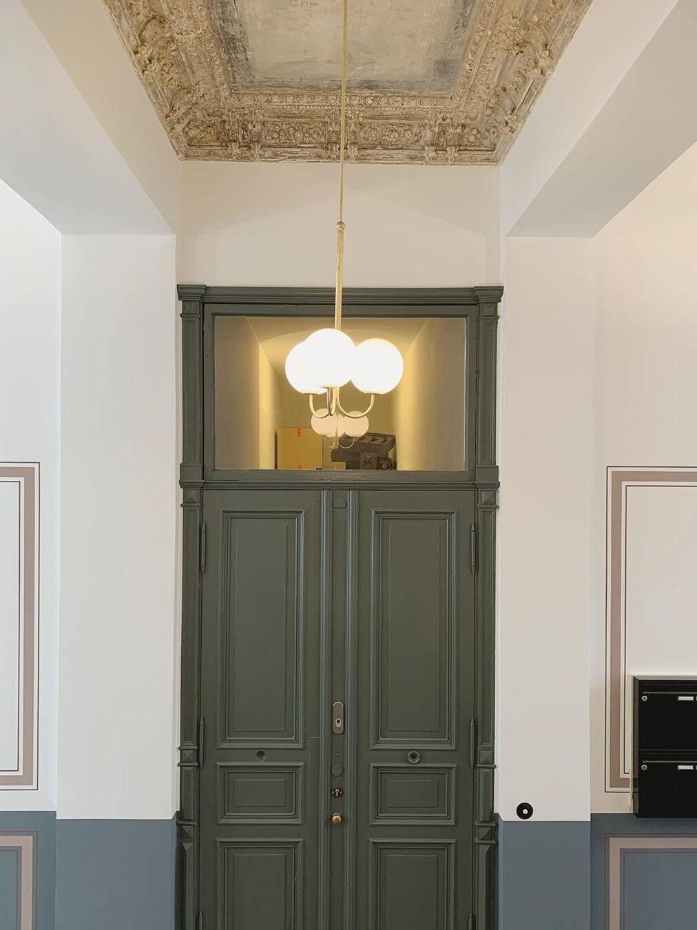 Angle three-globe pendant above a doorway