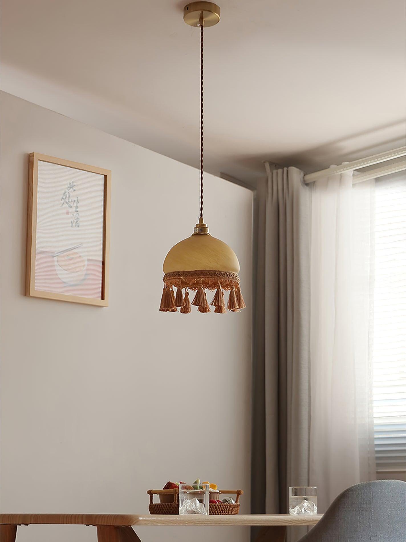 Tassel pendant above small dining table by window