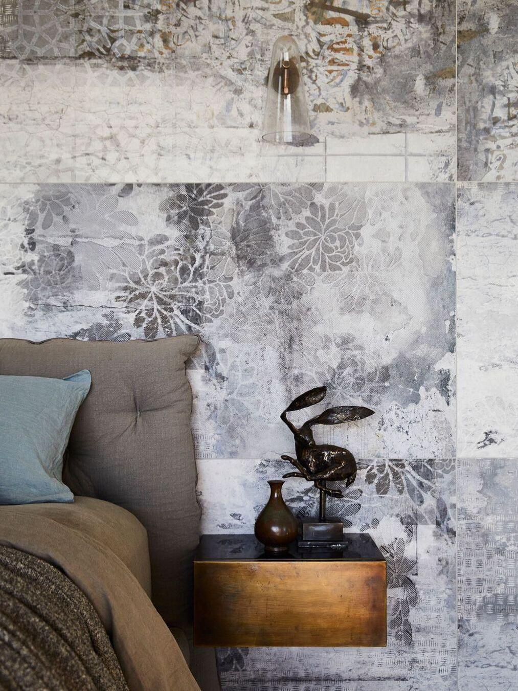 Clear glass wall shade above a bedside table