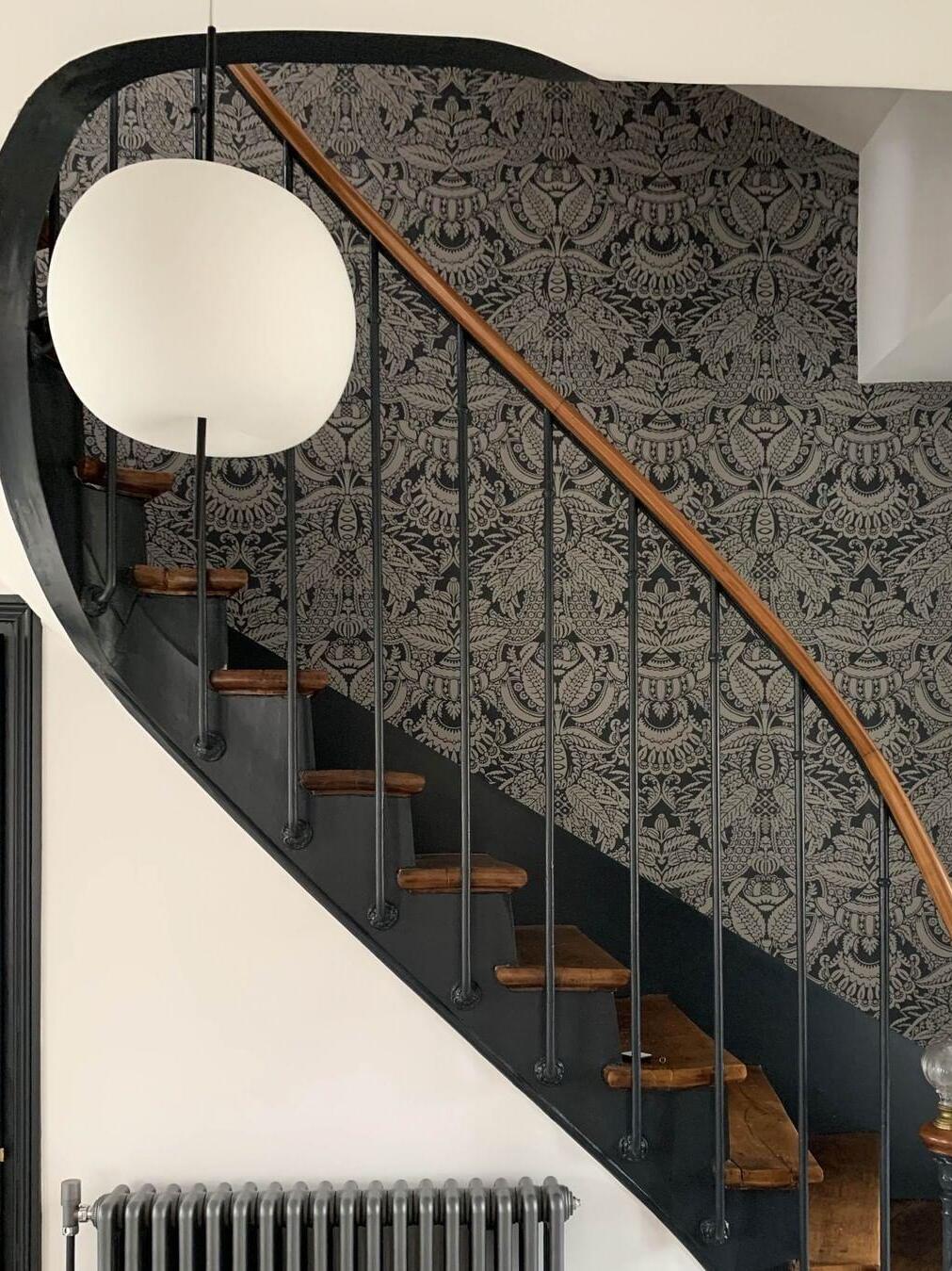 Rounded white pendant beside a staircase