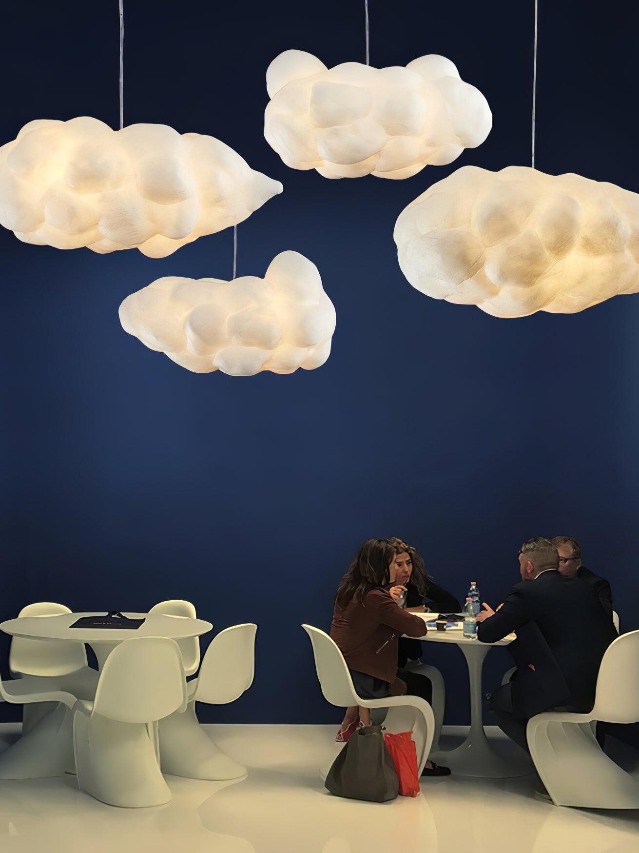 Grouped cloud-shaped pendants against a dark blue wall