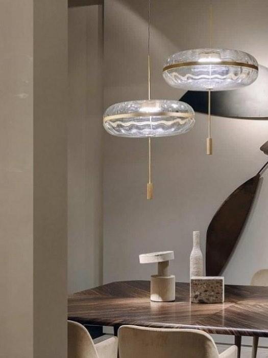 Two glass pendants over a styled table