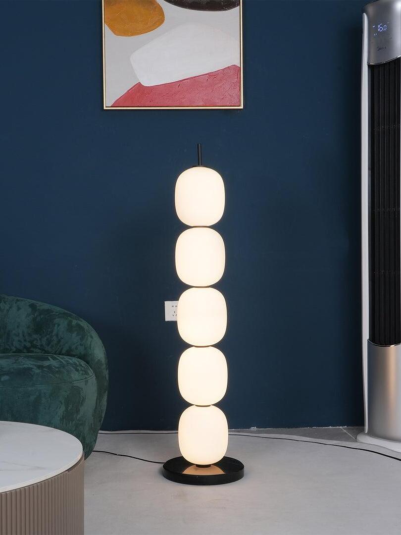 Five-globe floor lamp against blue wall