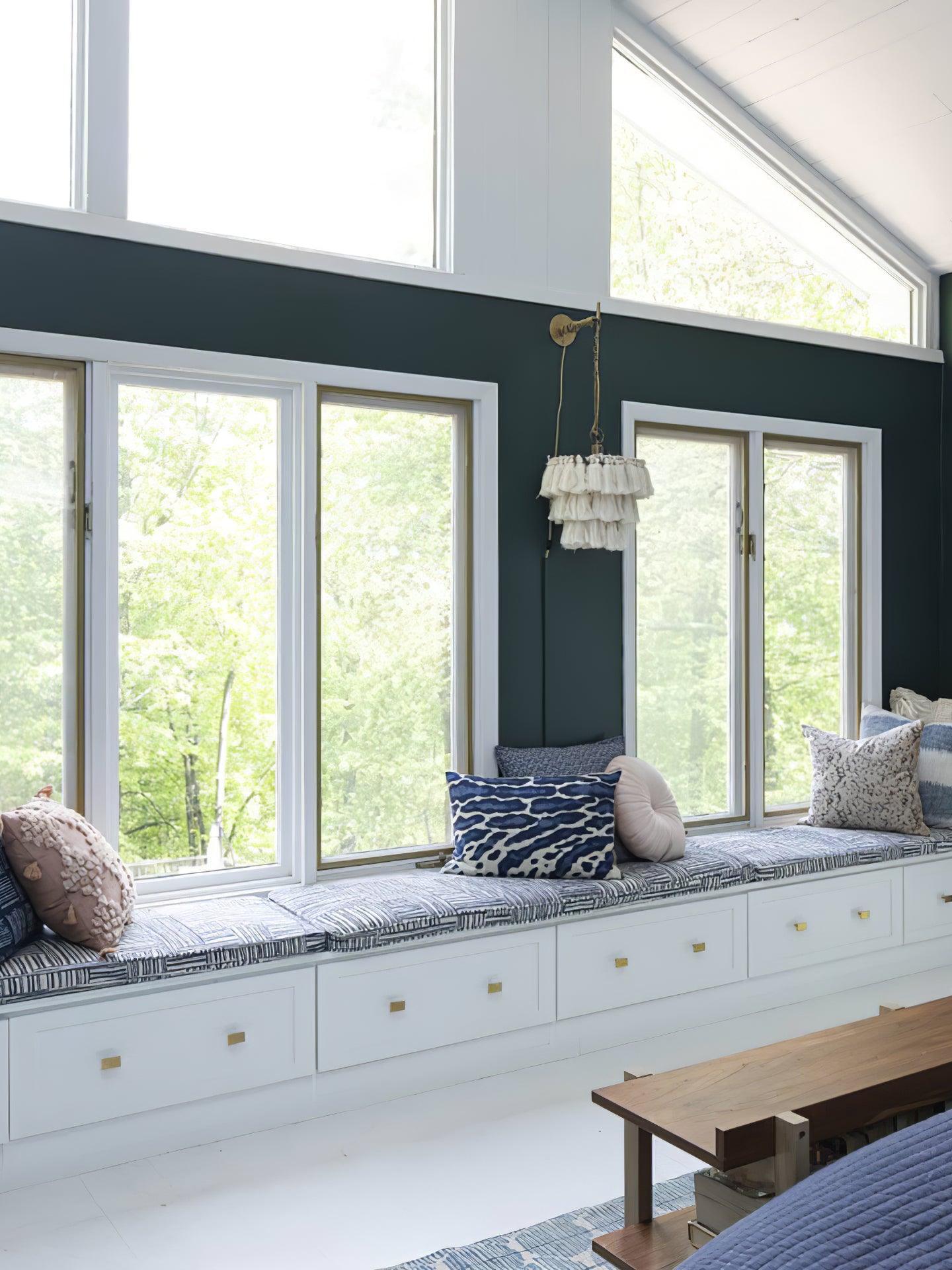White tassel wall fixture near a window seat