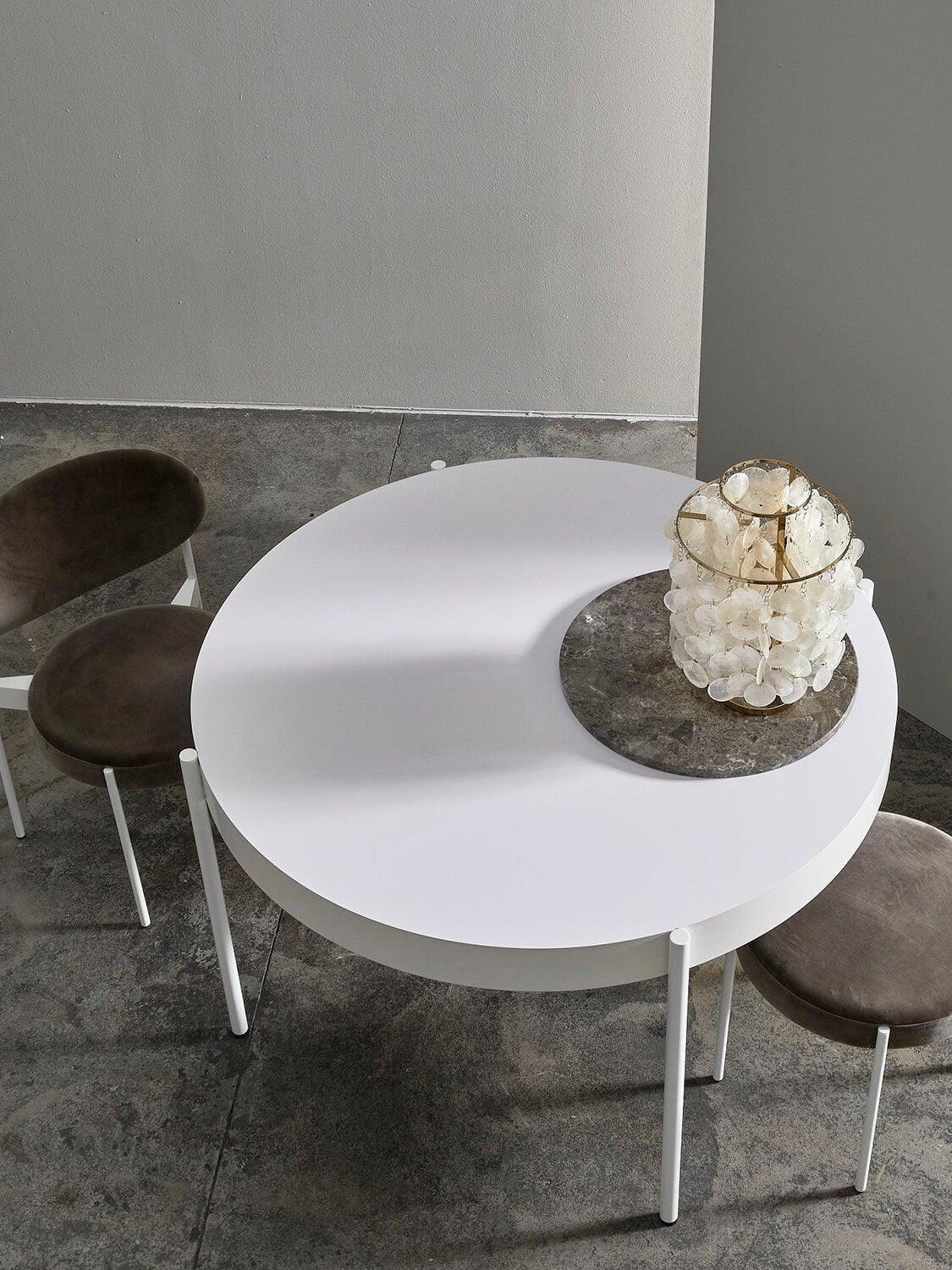 Overhead view of shell lamp on tray on white round table