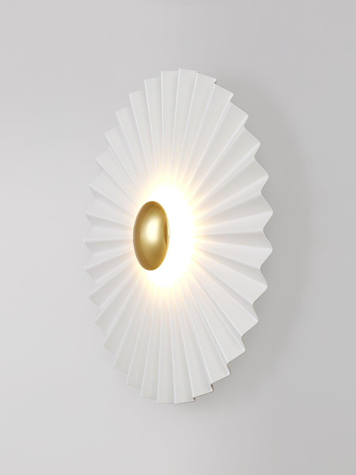 Side view of pleated white disc and gold centre