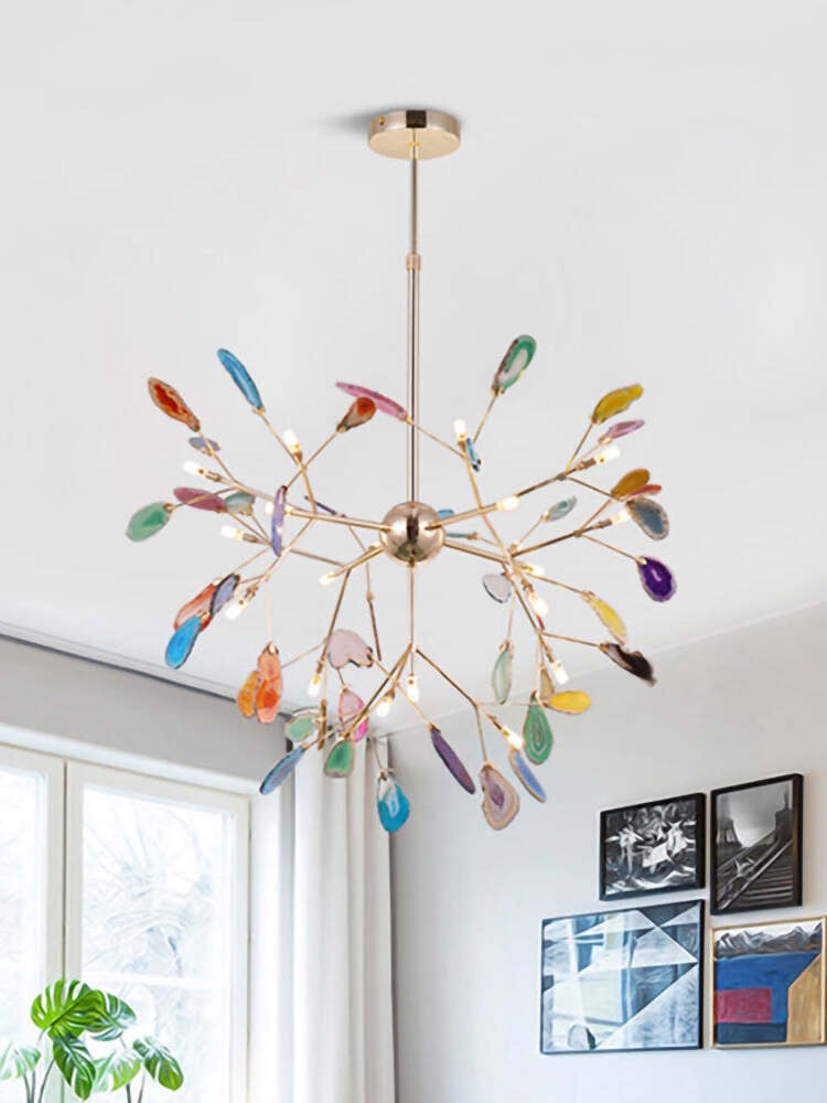Colourful stone-slice chandelier near a bright window