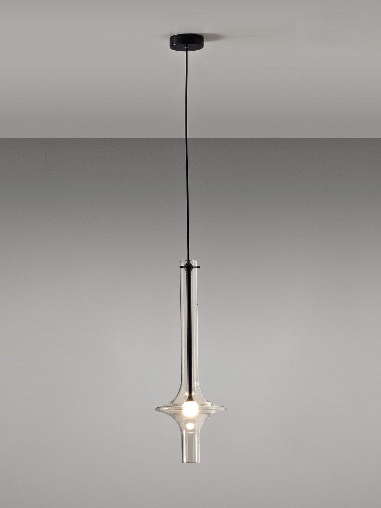 Single clear flared glass pendant with black central stem, black round canopy and black suspension cable