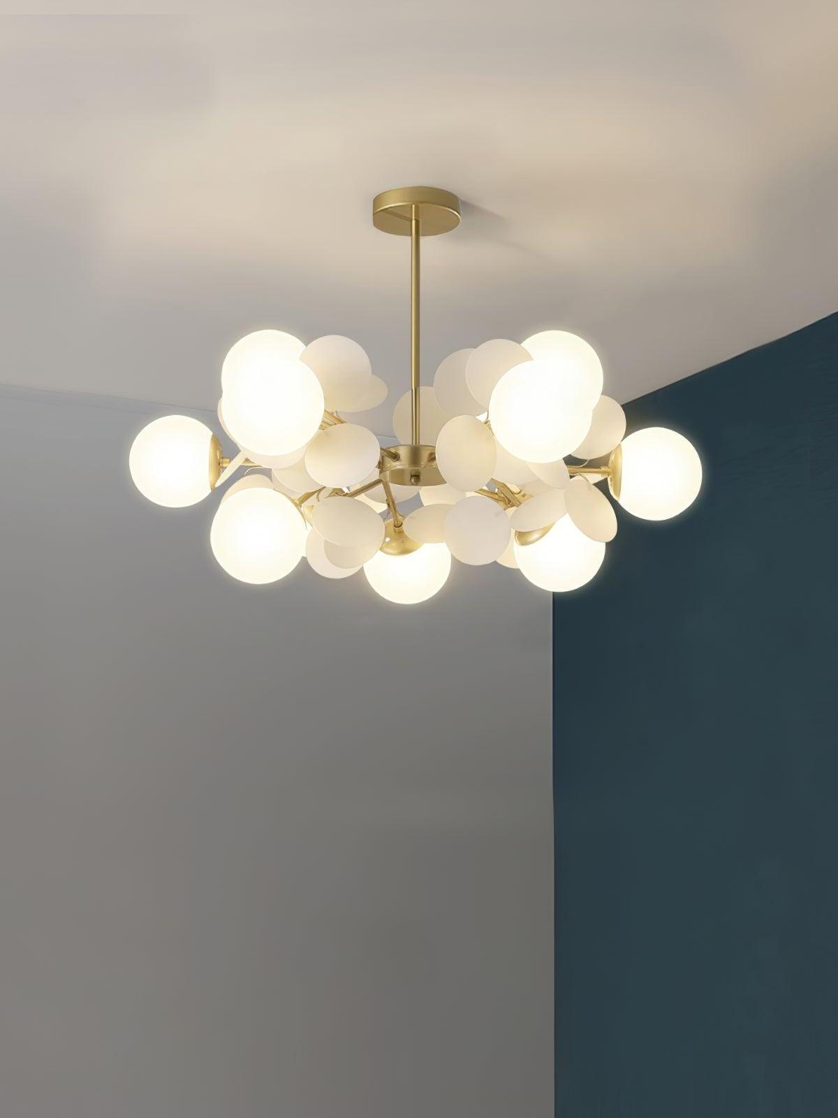 Gold branching chandelier with twelve white globes and white discs