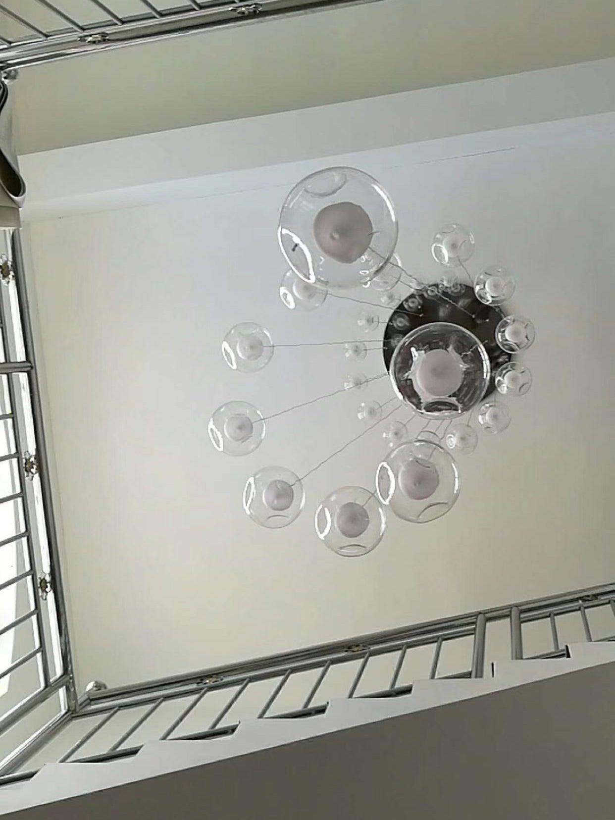 Underside view of clear globes and chrome ceiling plate
