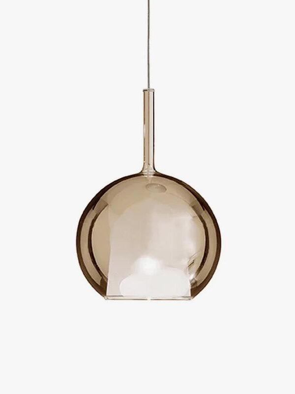 Amber-looking globe pendant with a white tapered inner shade and slender neck on white
