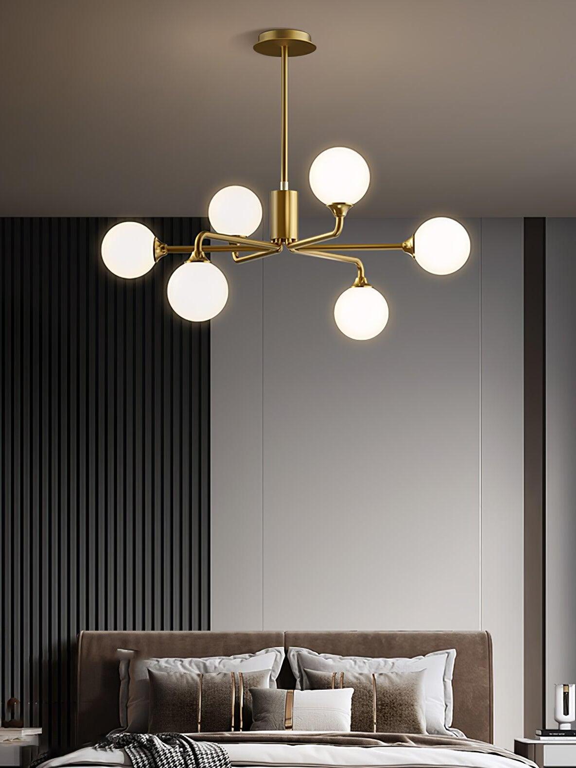 Six-globe chandelier over bedroom bed