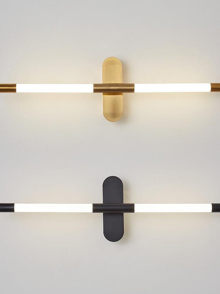 Gold and black Agnes wall lights shown horizontally on a pale background
