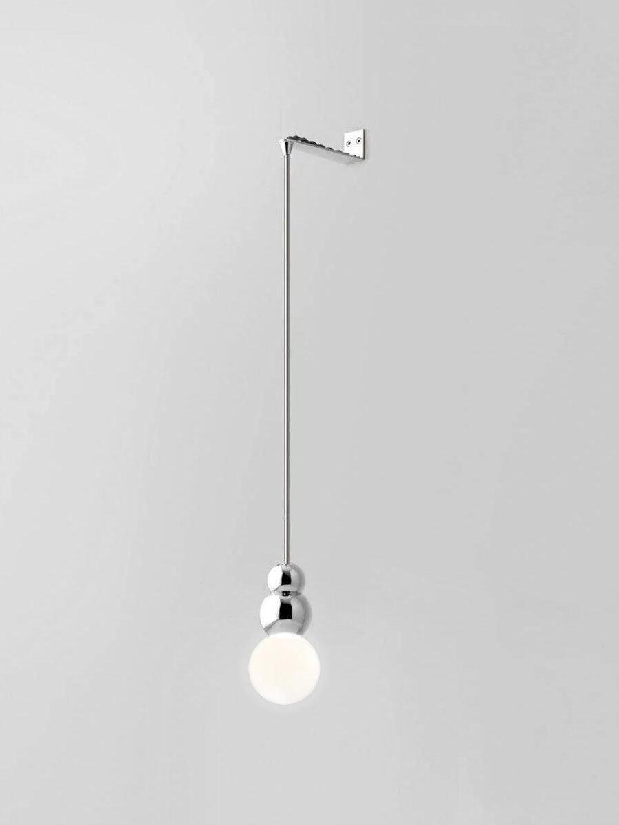 Chrome Rod wall light with larger glowing round bulb