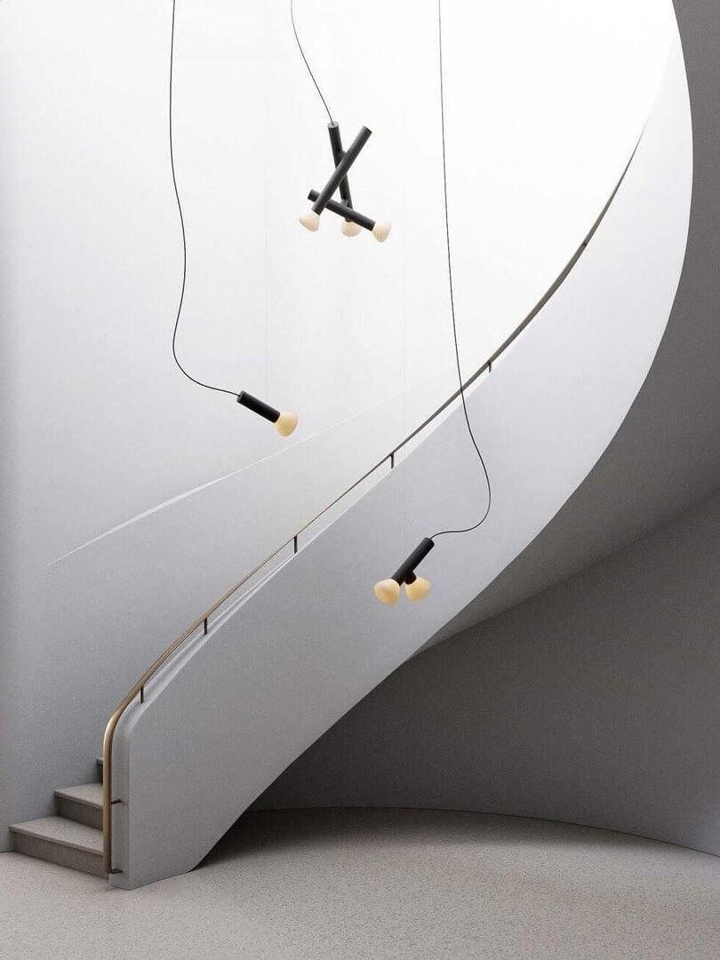 Tube pendants suspended at different heights in a stairwell