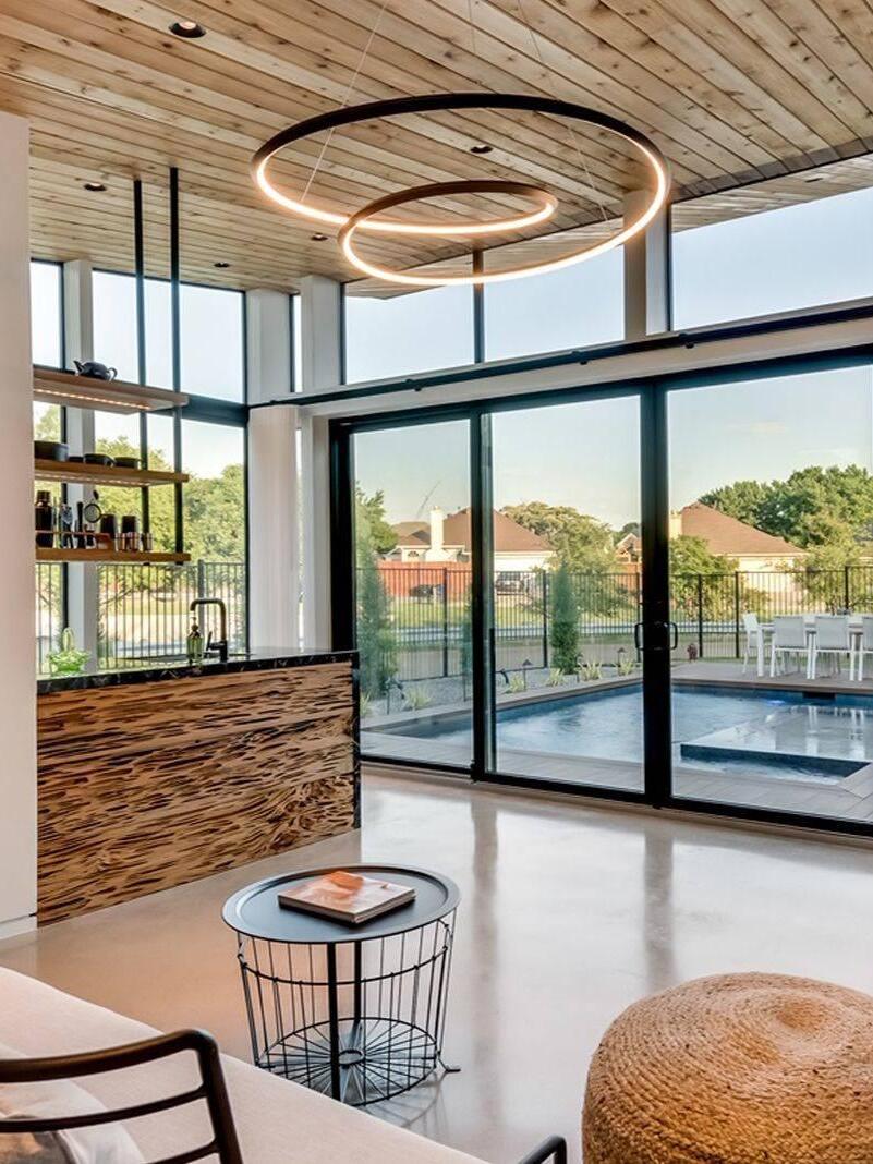 Lit looping chandelier under a timber ceiling