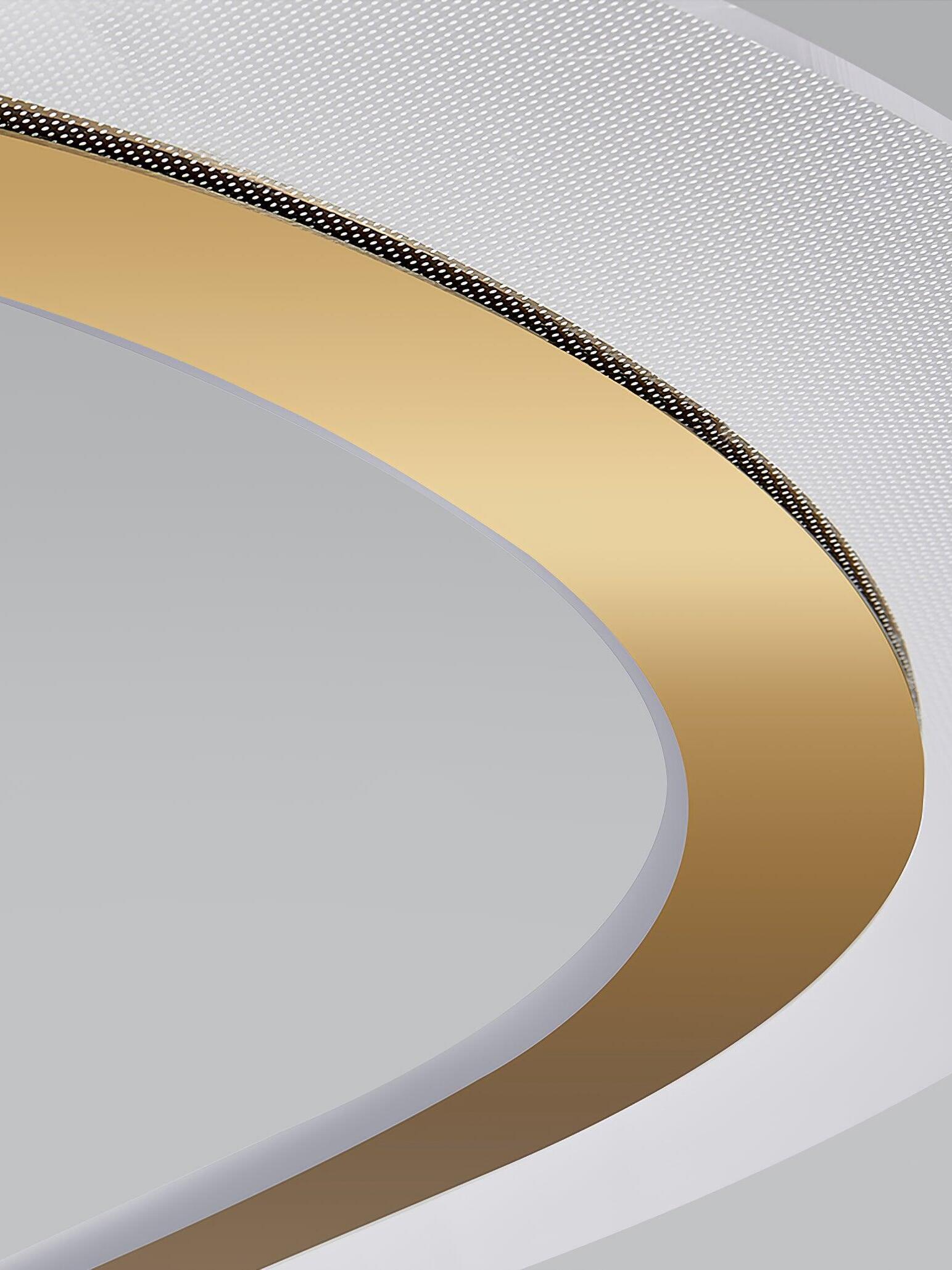Unlit patterned acrylic band beside the curved gold-tone strip