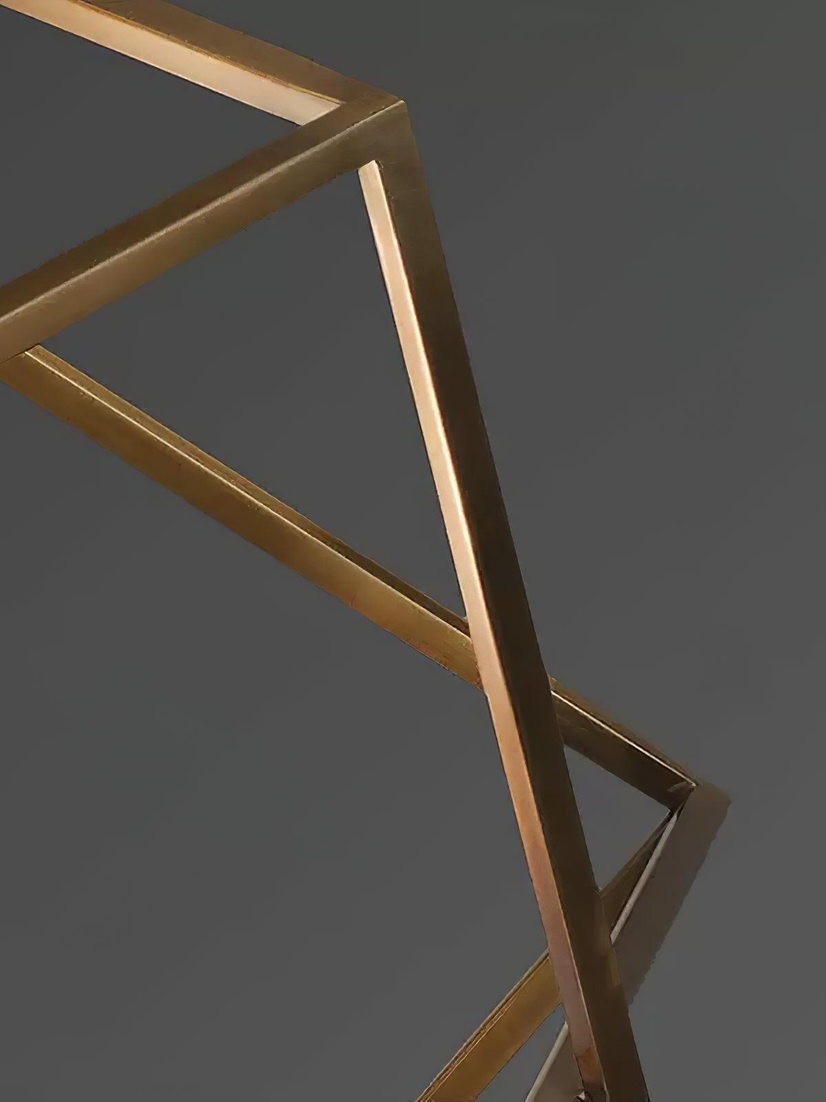 Close-up of intersecting brass-coloured frame bars on an Epic pendant