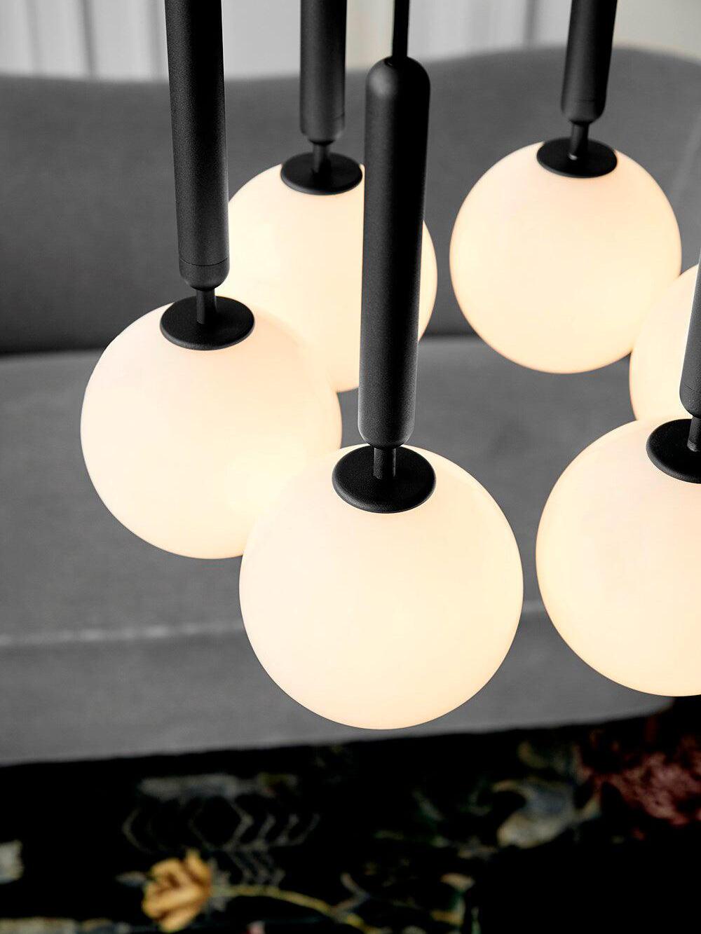 Grouped White glass globes and black stems close-up