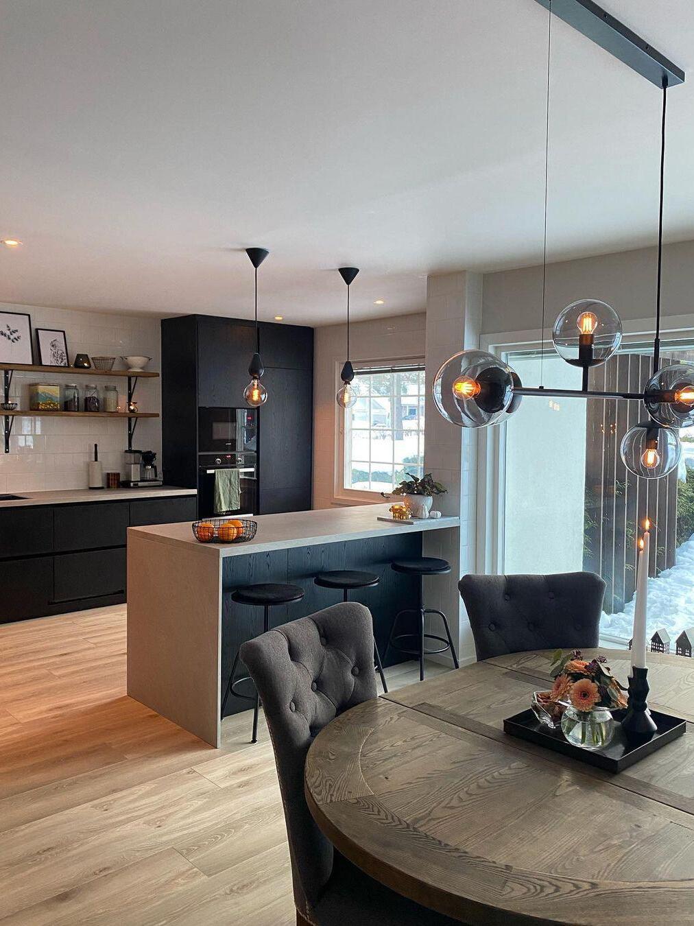 Glass globe fixture above a dark dining table