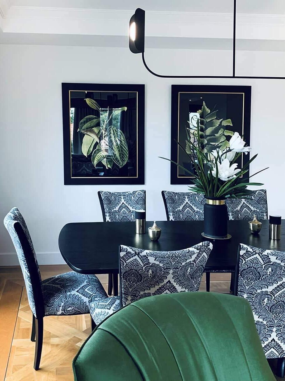 Black LEAF chandelier in a blue-walled dining room