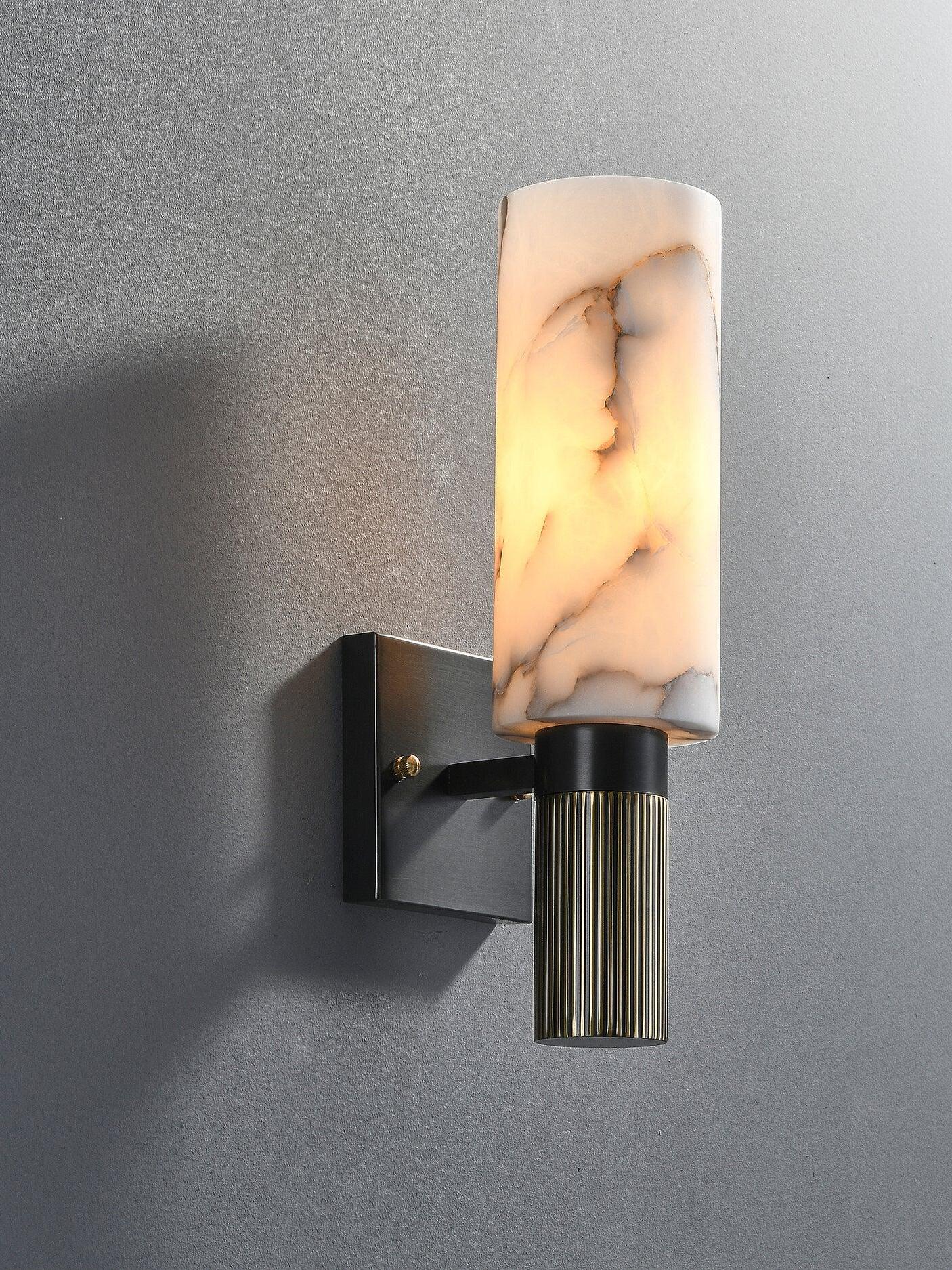Lit wall sconce showing black rectangular backplate