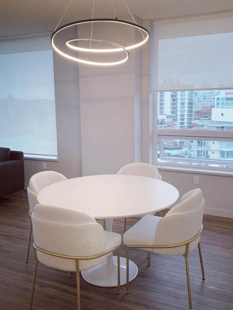 White illuminated loop above a round table