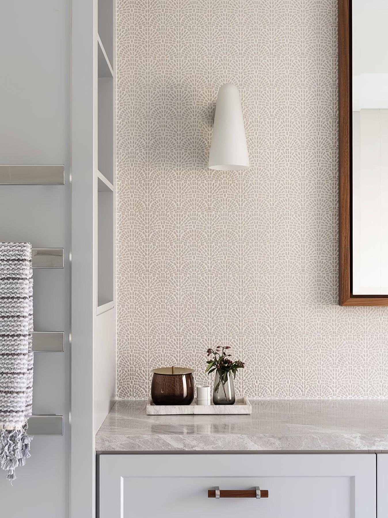 Pale conical wall shade above a vanity beside a mirror