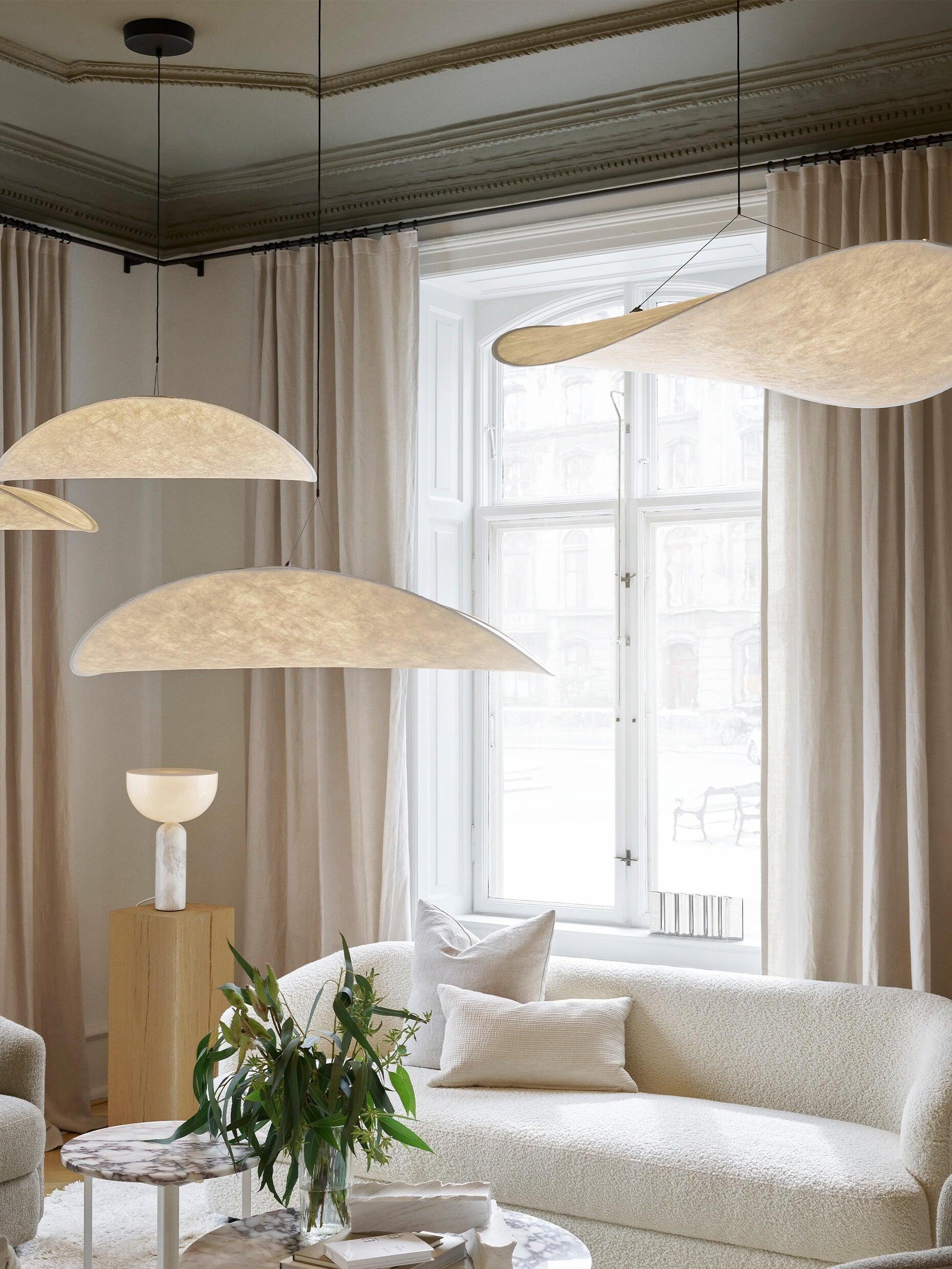 Several illuminated white shades in a bright lounge