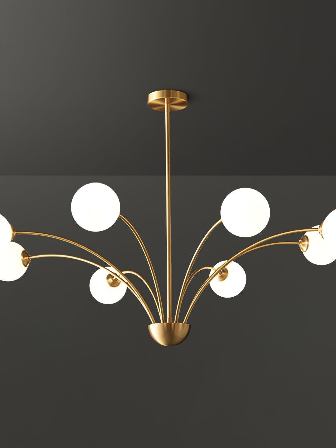 White-globe curved-arm chandelier with outer globes cropped at the sides and a round brass-tone canopy