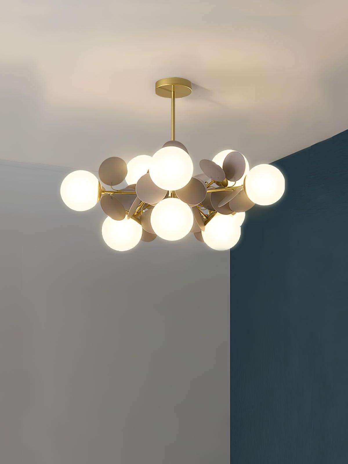 Gold branching chandelier with ten white globes and grey discs