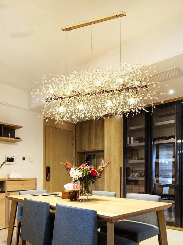 Gold branching chandelier above a table and blue chairs
