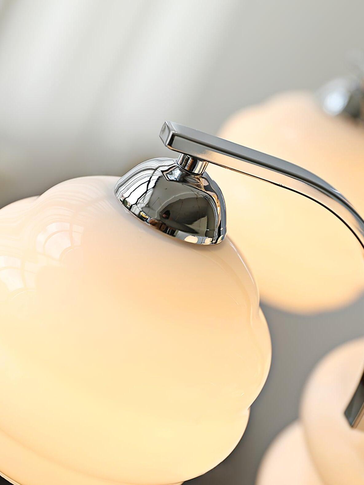 White glass shade glowing under a chrome cap