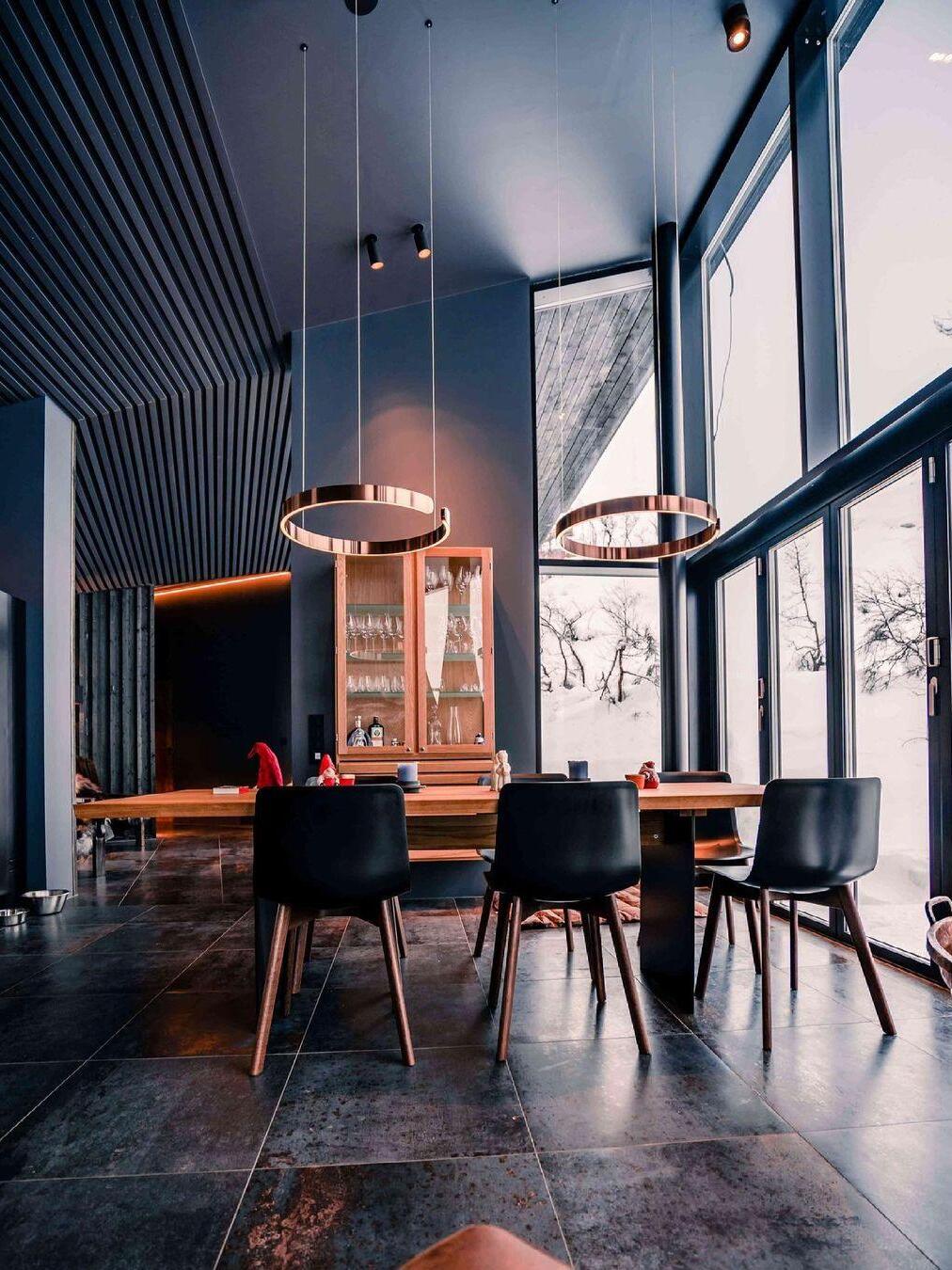 Ring pendants in a dark room with tall windows