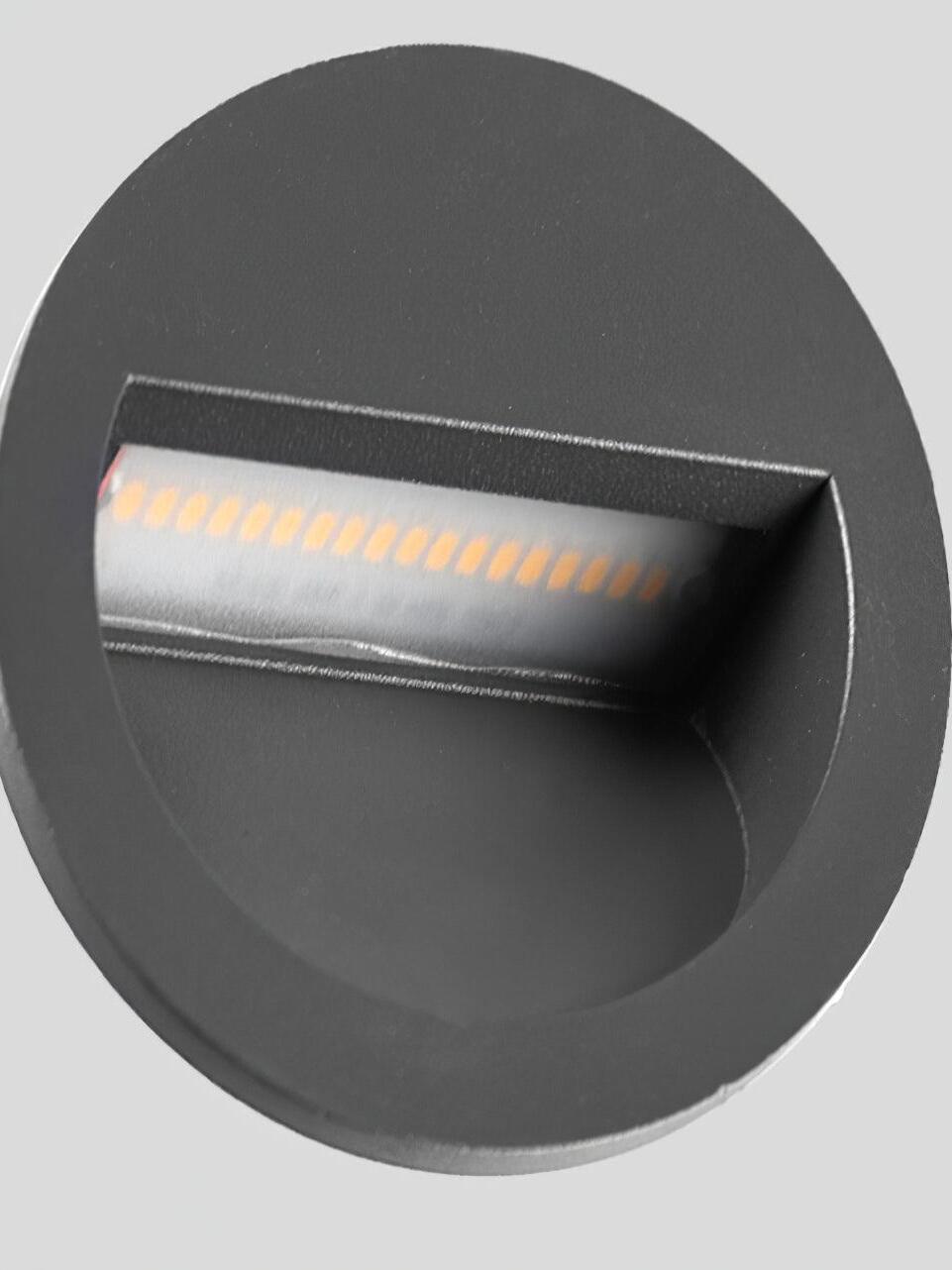 Close view of LED strip inside round black aperture