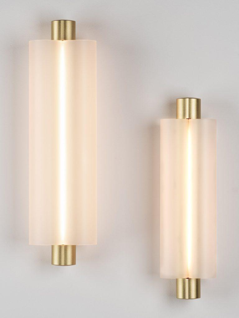 Front view of two gold-tone wall lights at different heights