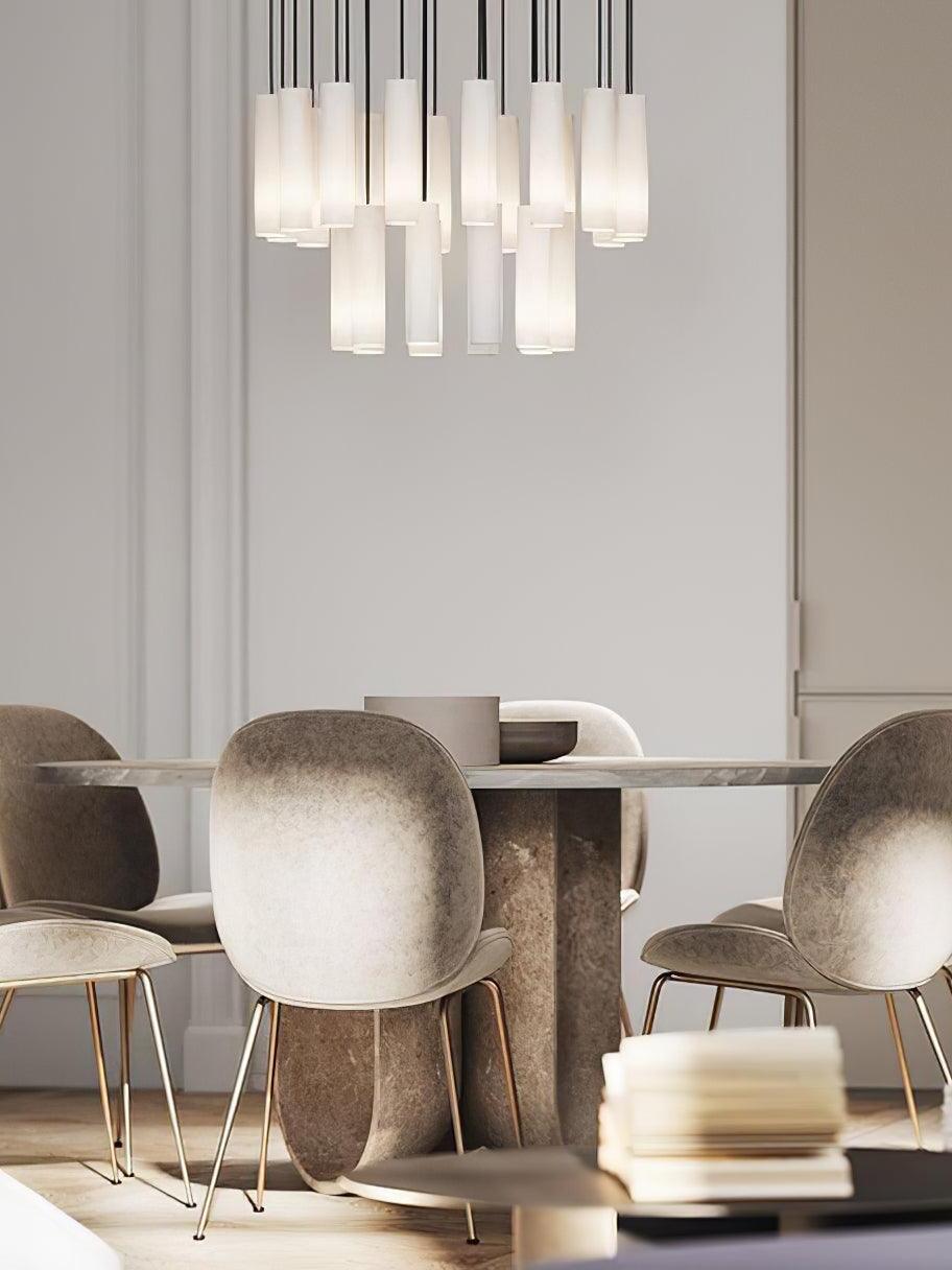 Glowing Silo cluster over a round wood dining table with pale upholstered chairs