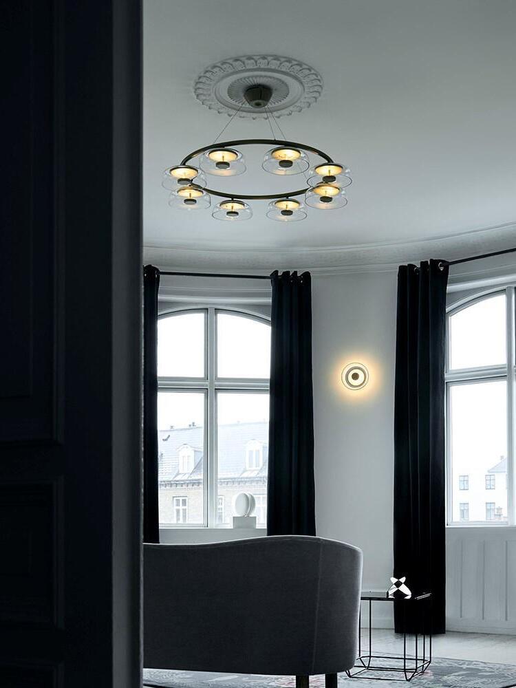 Illuminated chandelier beneath a decorative ceiling rose