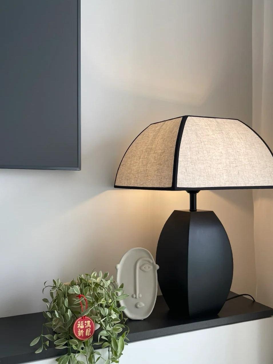 Javier lamp on narrow cabinet with plant