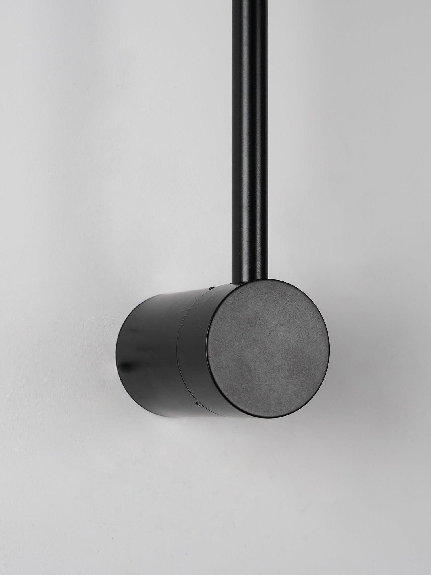 Black cylindrical mounting body viewed at an angle