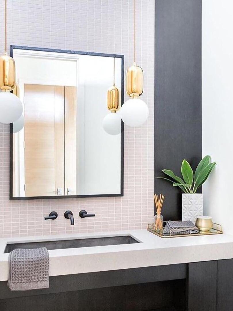 Paired globe pendants in a washbasin setting