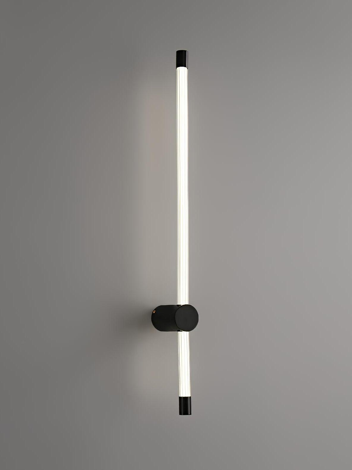 Black wall light with long upper and short lower luminous tubes around a round mount
