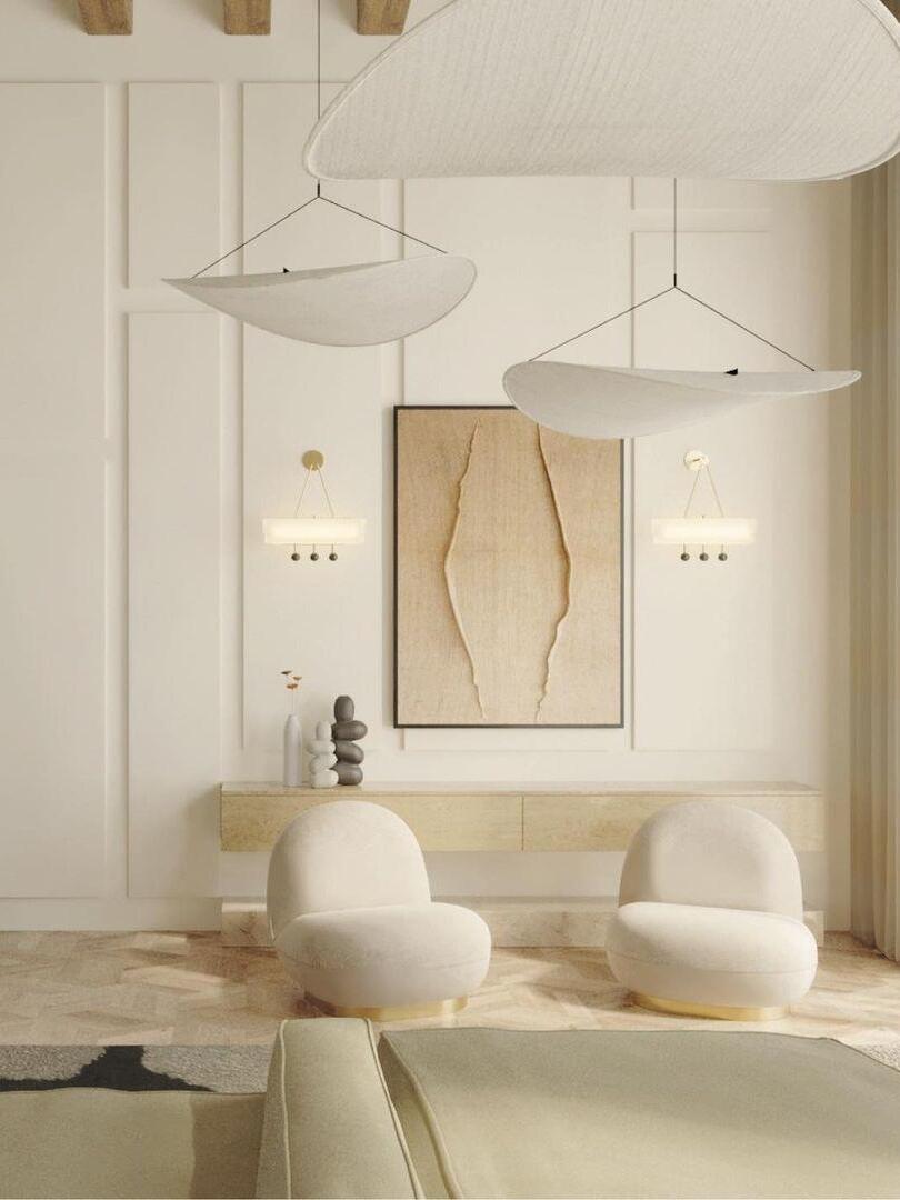 Two white sweeping shades in a pale interior